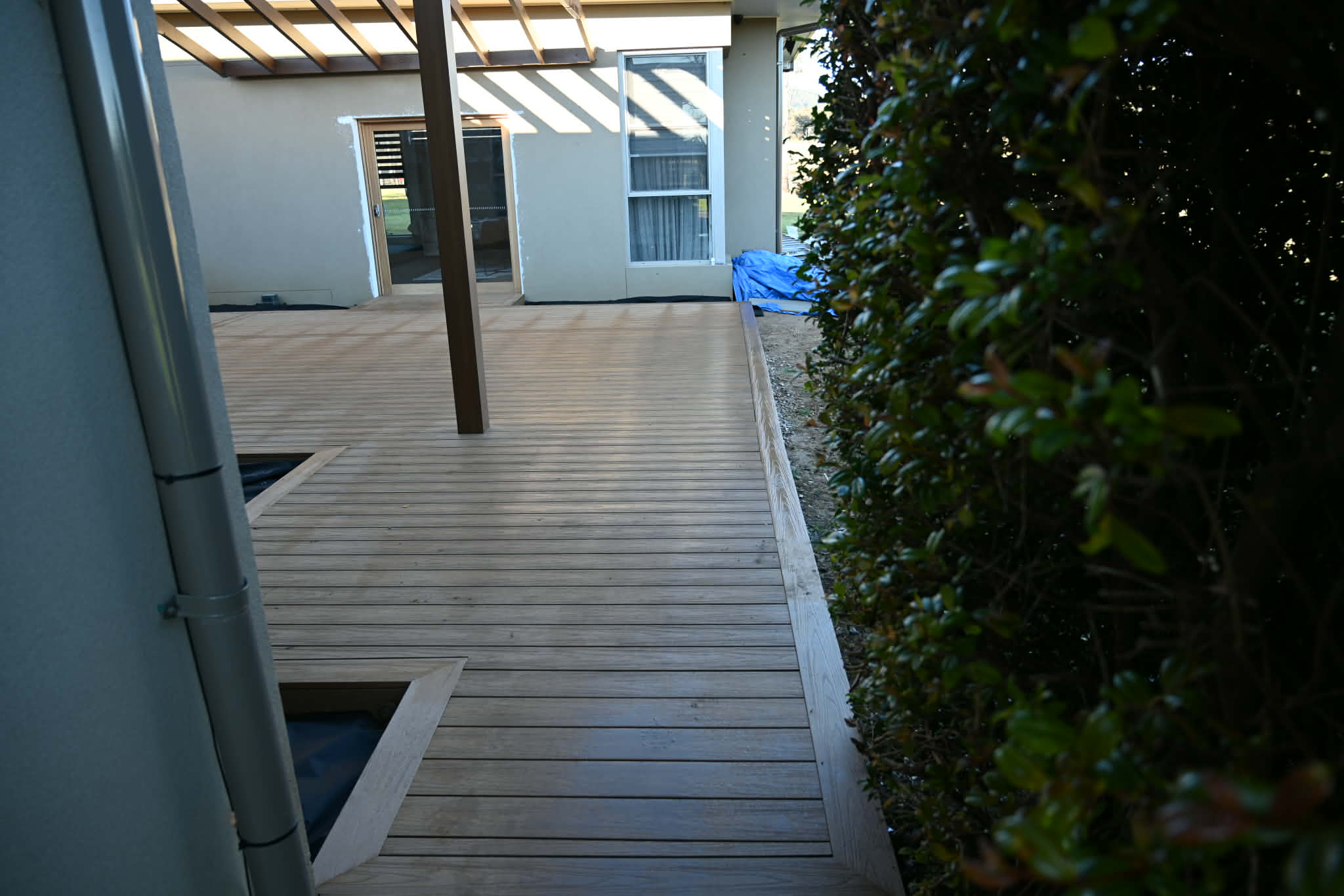 Composite deck under a timber pergola