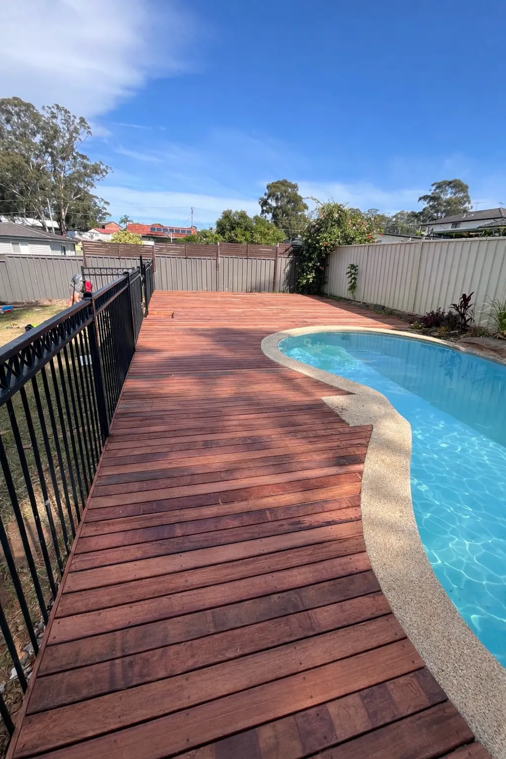 Hardwood deck beside a pool